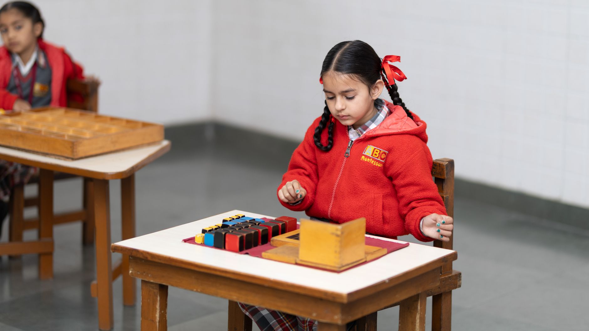 young girl engaged in montessori learning activity